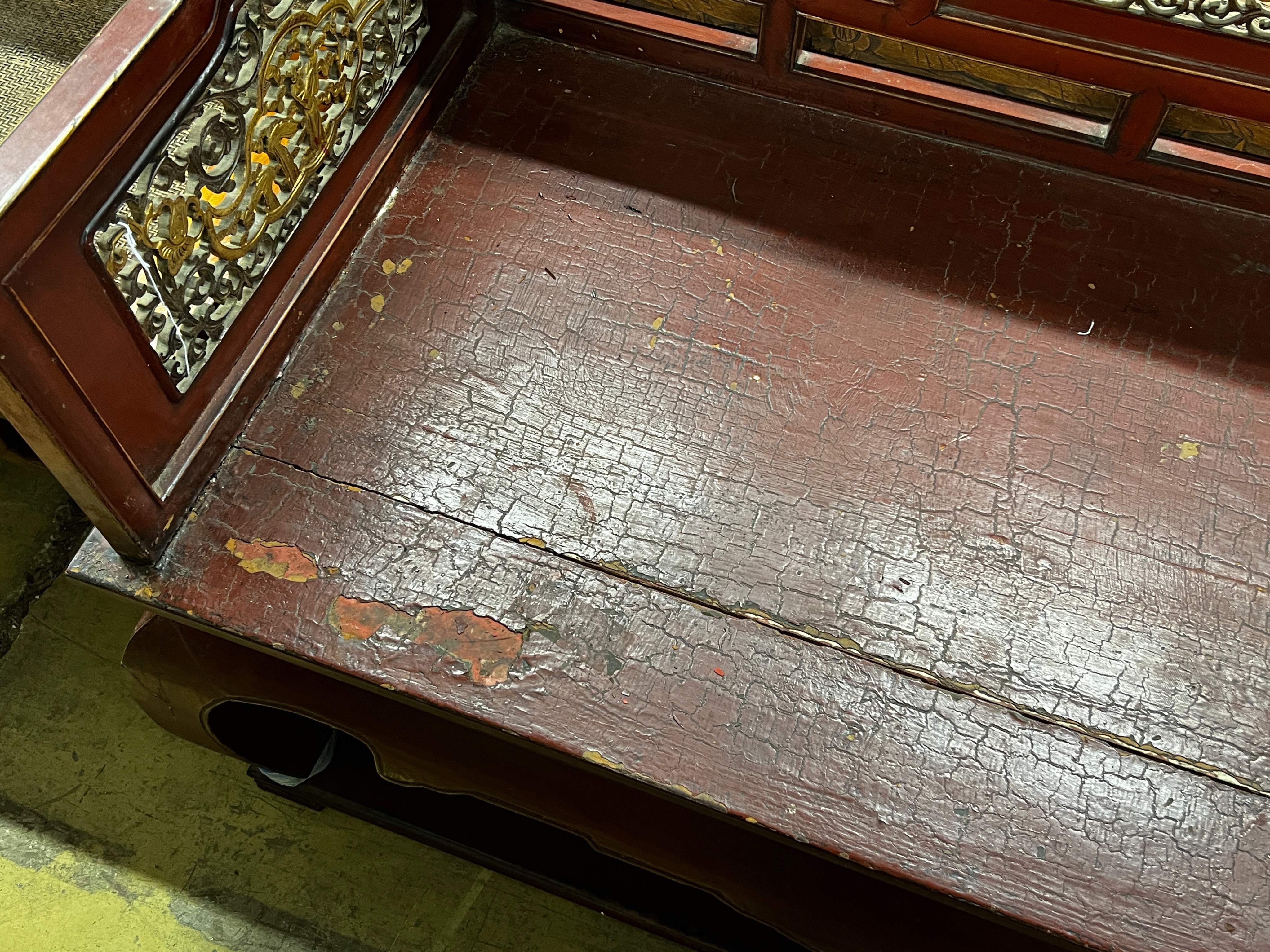 A Chinese scarlet lacquer parcel gilt bench, length 125cm, depth 70cm, height 97cm